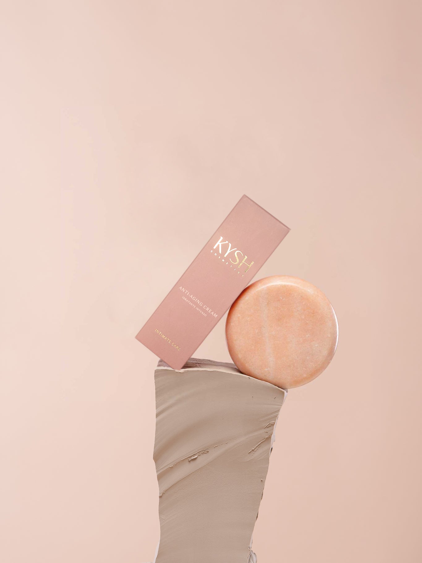 Rose gold disc and box with 'KYSH' branding on a pink background