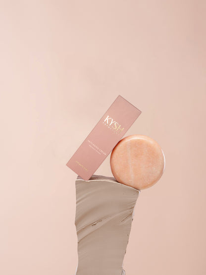 Rose gold disc and box with 'KYSH' branding on a pink background